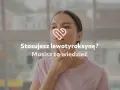 Kobieta dotyka szyi, na zdjęciu widoczny symbol serca i tekst "Stosujesz lewotyroksynę? Musisz to wiedzieć".