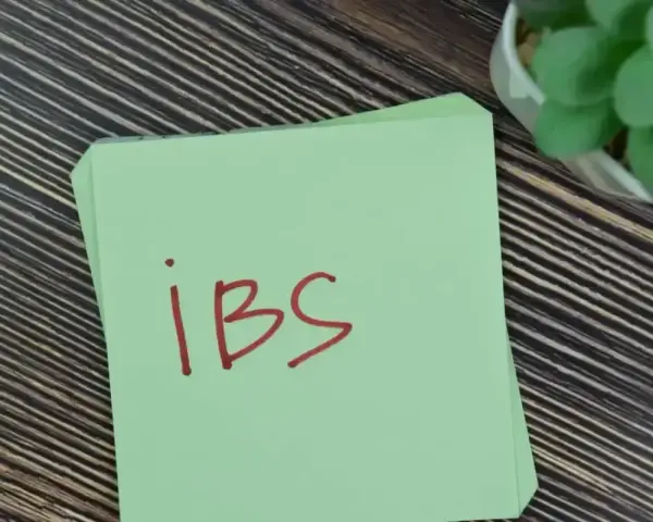 Napis "ibs" czerwonym markerem na zielonej kartce.