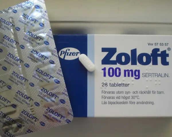 Zoloft co to? Opakowanie leku Zoloft 100 mg z sertraliną, blister z tabletkami i pojedyncza tabletka.
